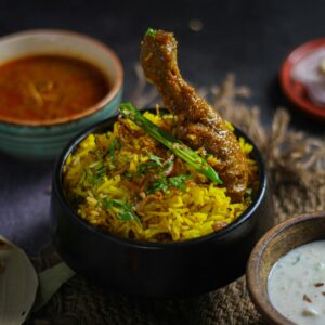 Delicious chicken biryani served with traditional Indian condiments, capturing vibrant flavors and spices.