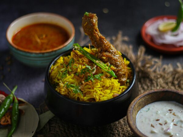 Delicious chicken biryani served with traditional Indian condiments, capturing vibrant flavors and spices.